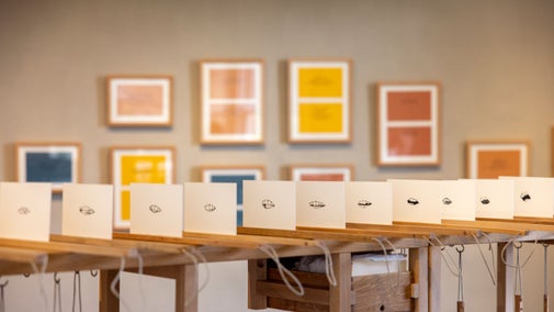 Art exhibition with framed color works and interactive black-and-white prints on display at Allan Bank, Grasmere.